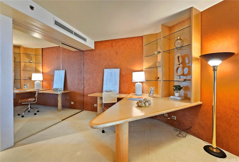Second bedroom with bespoke custom furniture featuring large work desk and couch that doubles as a bed