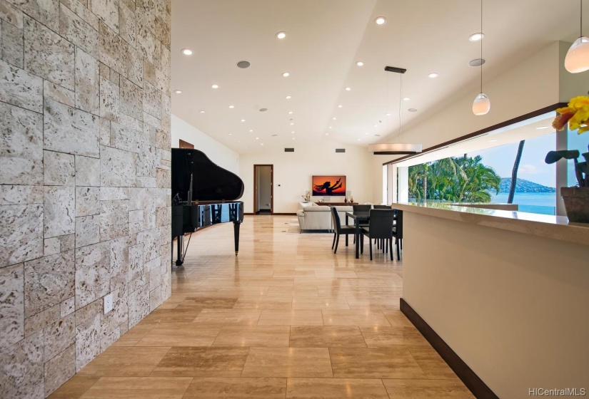 Spacious, open floor plan is ideal for entertaining. Custom coral rock wall accents and complements the modern style of simple and clean lines.