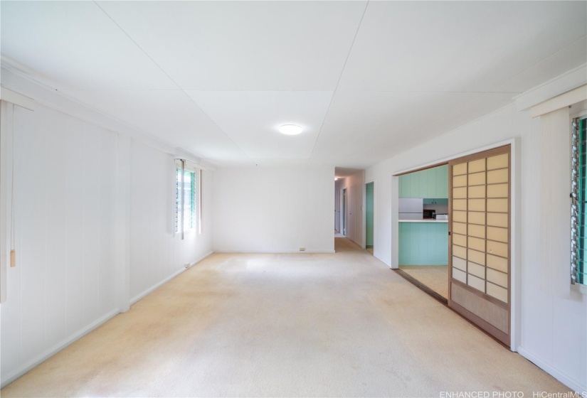 Living room area with original triple-track shoji door enhanced