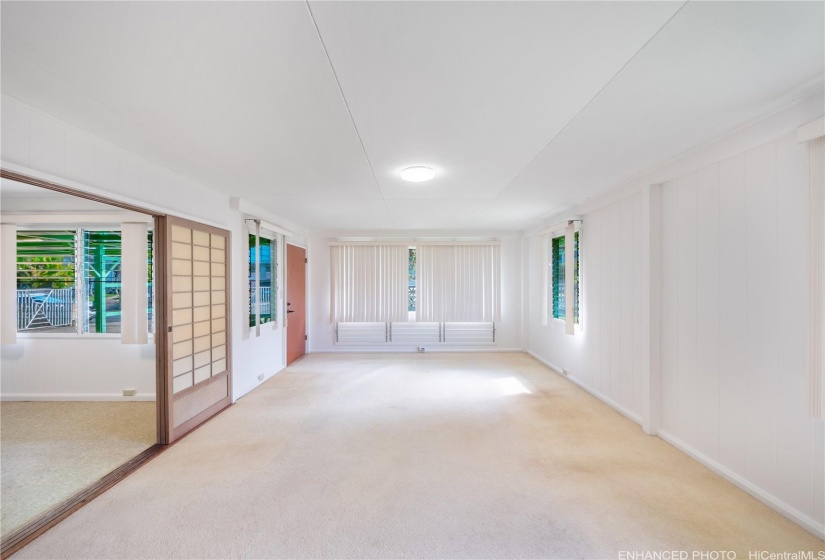 Large front windows in living room enhanced