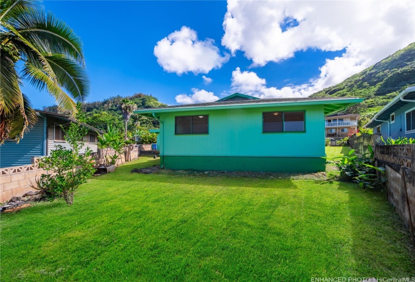 Backyard has a lime tree and lots of room for yard play, pets, gardening, etc. enhanced