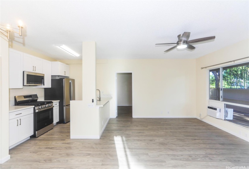 Another view of the kitchen and the living room with the Bedroom door straight ahead