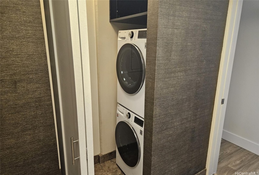 Stack Washer/Dryer and storage behind bifolds in guest bath