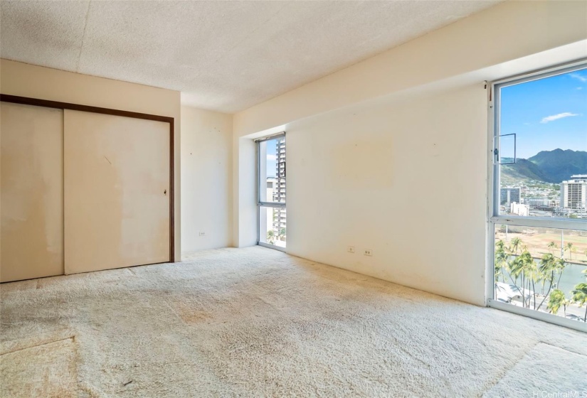 The generous sized bedroom has a large closet and windows that open, letting in the trade winds.
