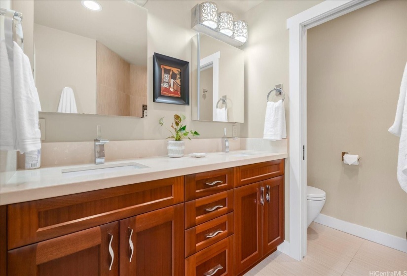 The spacious primary bath features dual sinks and medicine cabinets for couples.
