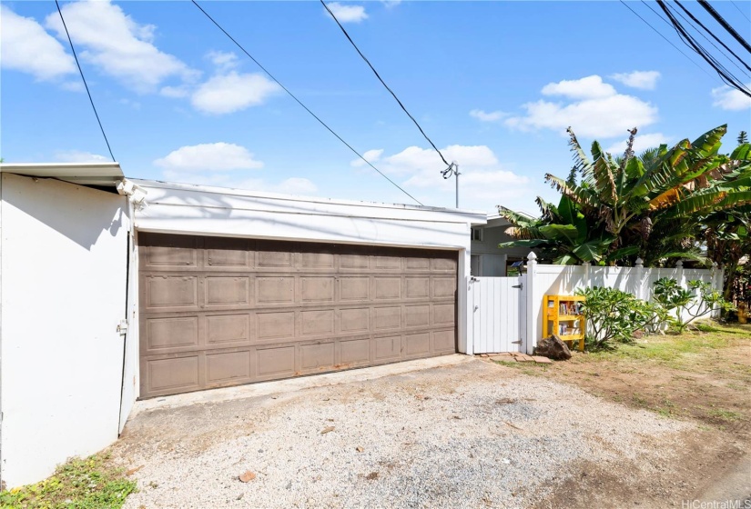 A simple modern inviting front view of home with white vinyl fence that adds charm and curb appeal.