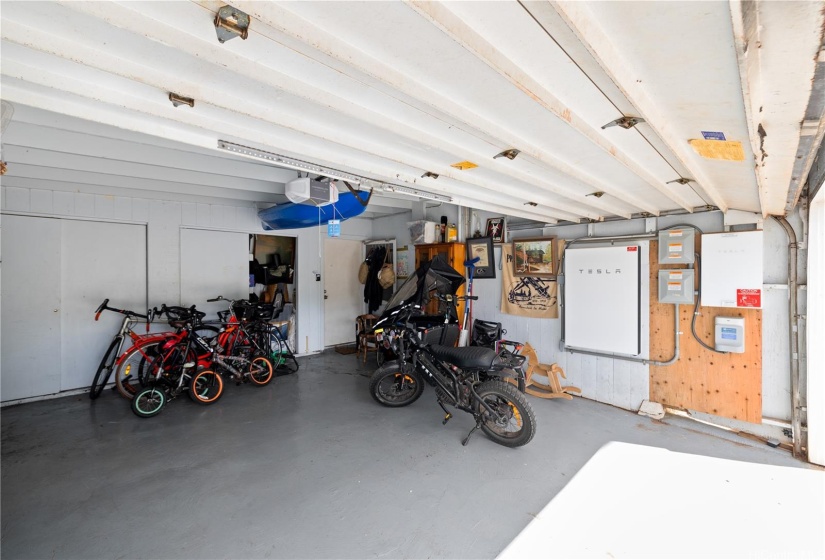 This convenient 2 car garage not only offers ample storage space but also features a built-in Tesla battery, perfect for eco-conscious living.