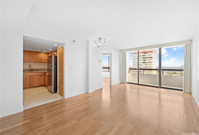 Open living room with engineered hardwood and access to your covered lanai