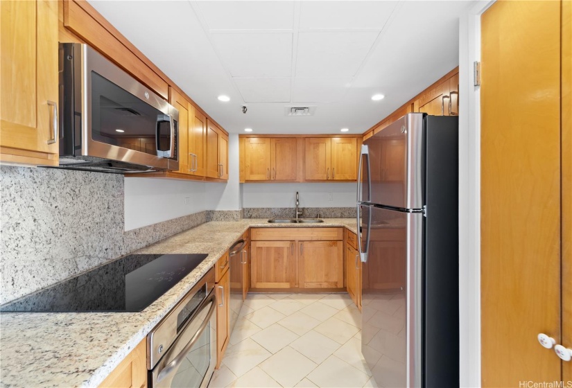 Updated kitchen with granite countertops, hardwood cabinets and stainless steel appliances