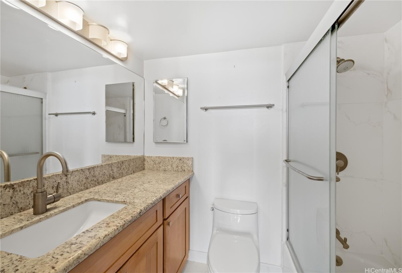 Primary bath with granite vanity, tub and tiled shower