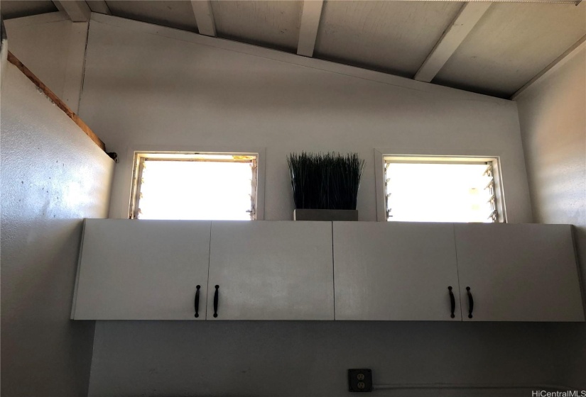 The kitchen cabinets in the studio- vaulted ceilings with lots of light.  some of the windows have been changed to slider windows.