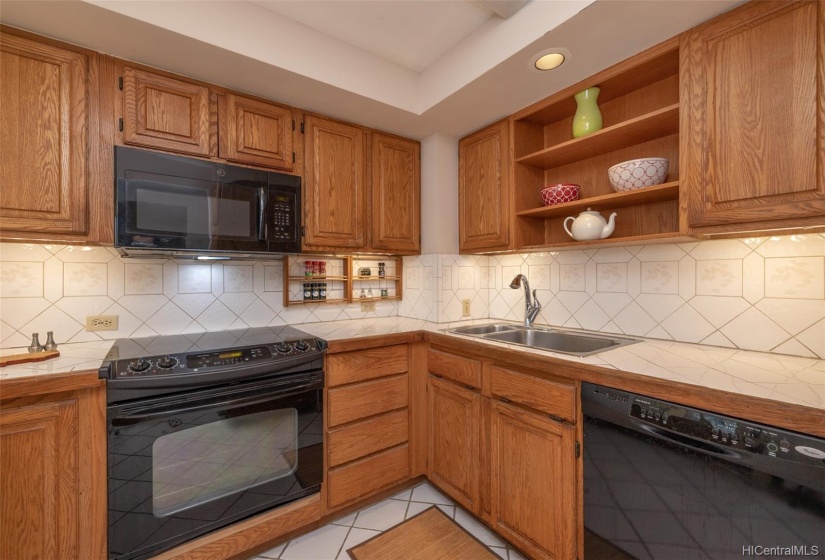 The kitchen has an abundance of counter and cabinet space as well as cool and easy to care for ceramic tile floor.