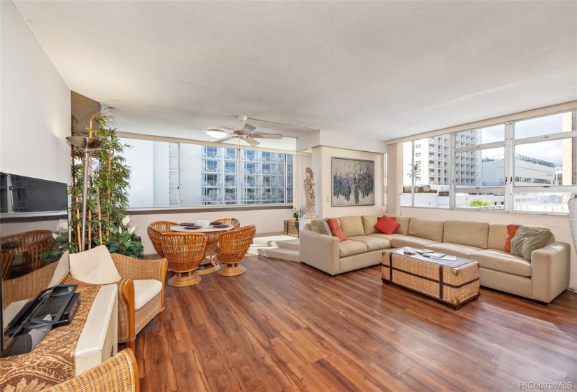 Big and bright living room can accommodate several functional areas - dining, entertaining, and quiet contemplation.  In addition to lots of light, the windows provide cool cross breezes.