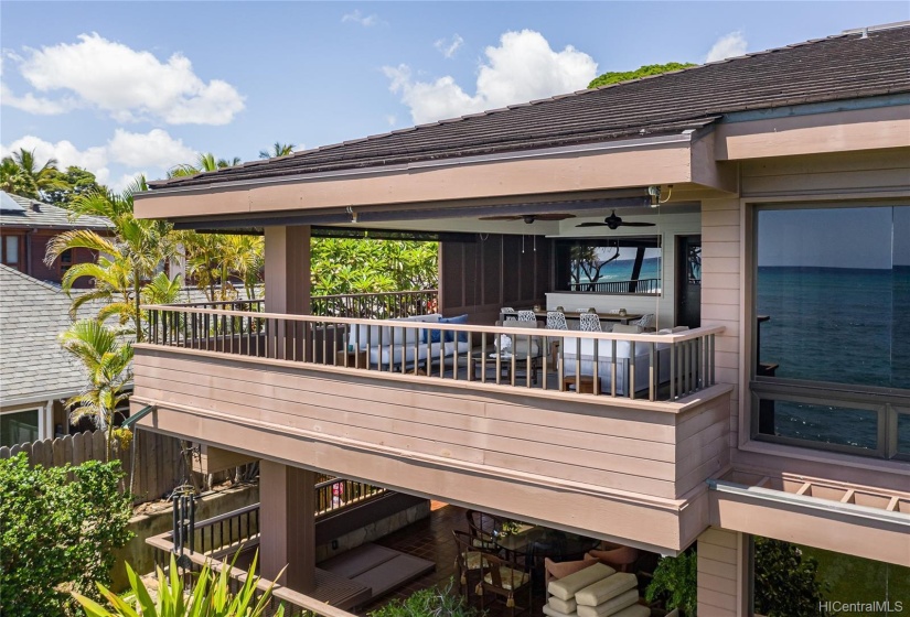 ~500 sf lanai with retractable shutter wall, wet bar, power solar shades, and new ceiling fans.