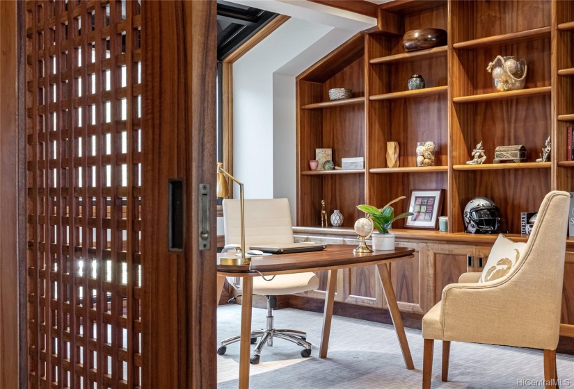 The office/library is just inside the front door. When seated at the desk, Diamond Head towers out the windows behind you and the Pacific stretches out in front of you.