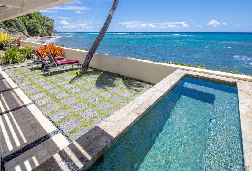 The relaxing Jacuzzi has almost a seamless view to the water.