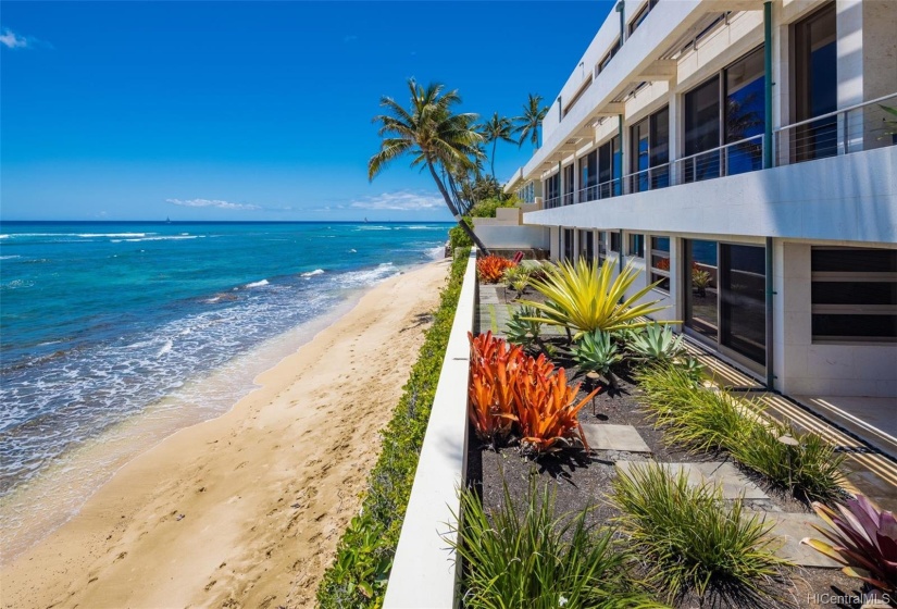 Fronting a wide sandy beach area.