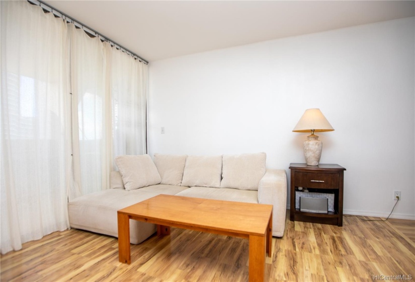 laminate flooring in living room, hallways, and bedroom.