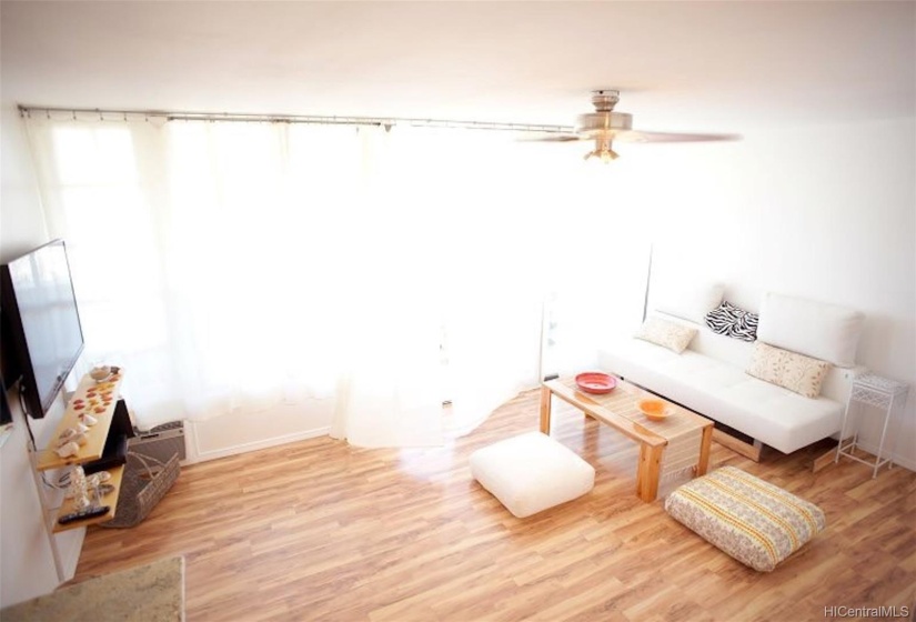 view from the kitchen towards living and lanai. Wall to wall windows for lots of light.