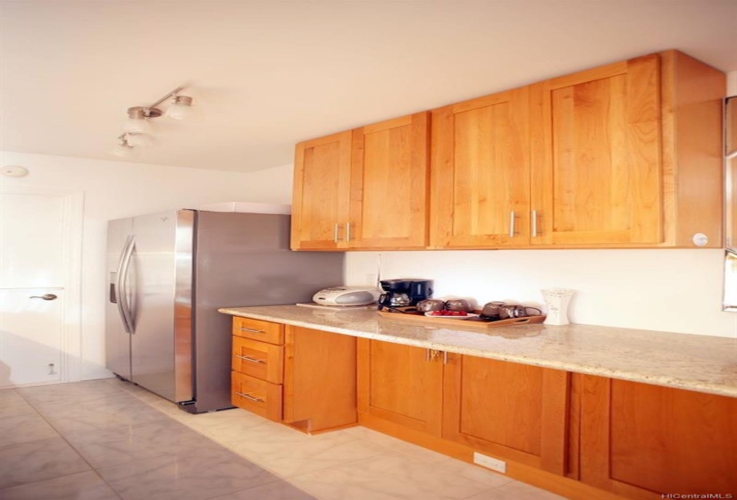 more counter space and cabinets for storage.