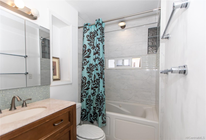 renovated bathroom with deep jacuzzi tub and small window for extra ventilation. space saving 