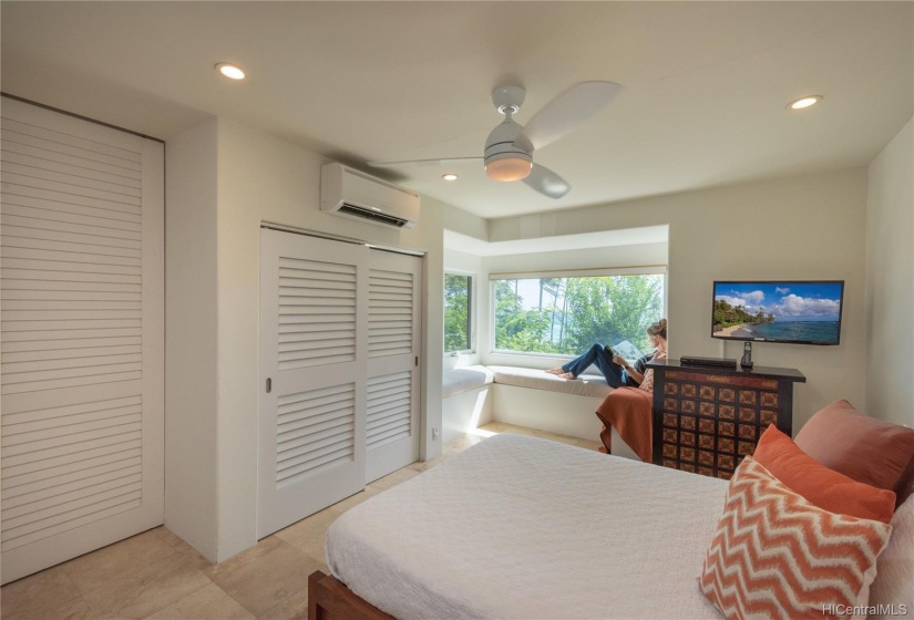 One of three bedrooms on the cool lower level, this room has a window seat perfect for reading a book overlooking the view.