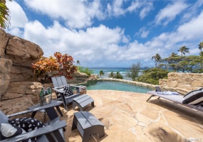 Coral rock and a waterfall encircle this unique hillside pool that looks out over the surf and Leahi Park.