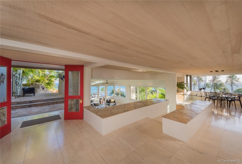 A look back to the landscaped, welcoming entry experience. Ocean views from the entry, living room and dining area can all be seen in this photo. Open floor plan that truly brings the outdoors in. Fabulous views from every angle.