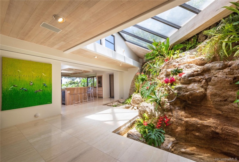 A bit of Diamond Head's hillside flows through the living area with this water feature and grotto.