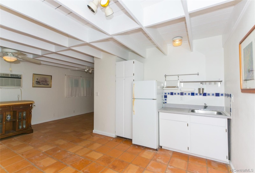 Cottage with bar sink and refrigerator with a window ac unit