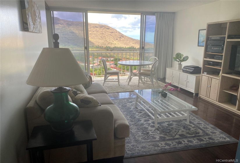 Spacious Living Area With Hardwood Floors. Large Doors leading to the Lanai Overlooking the Mountains, Valley, and Ocean.