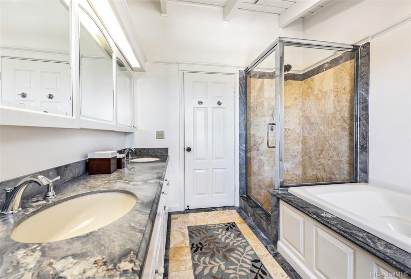 Primary bedroom bathroom with separate tub and shower.