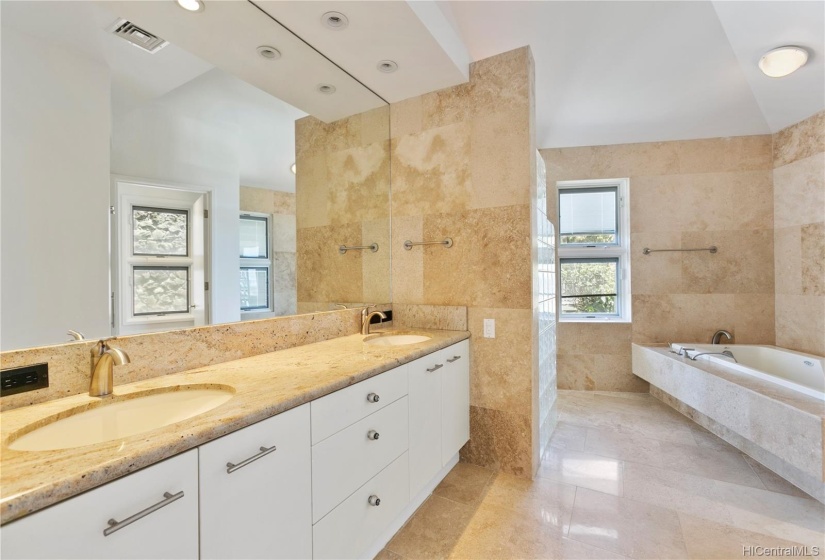 Travertine tiling, dual sinks and a shower with a view & spa soaking tub!Virtually Staged