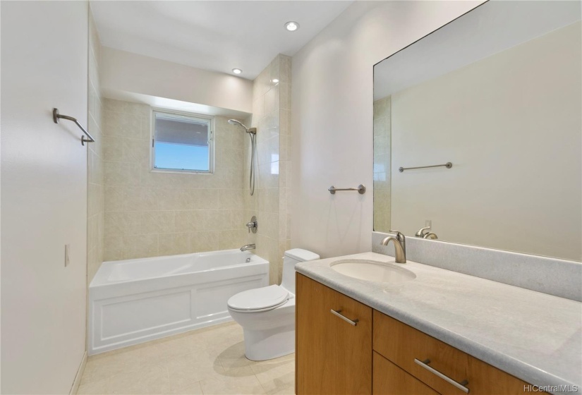 Bathroom 1 with re-glazed bathtub & walk in closet.